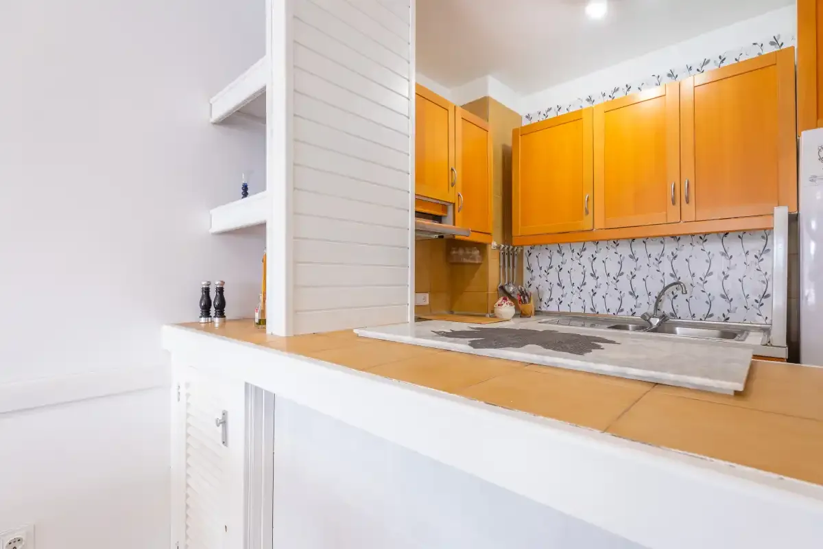 A kitchen with orange cabinets and a countertop.