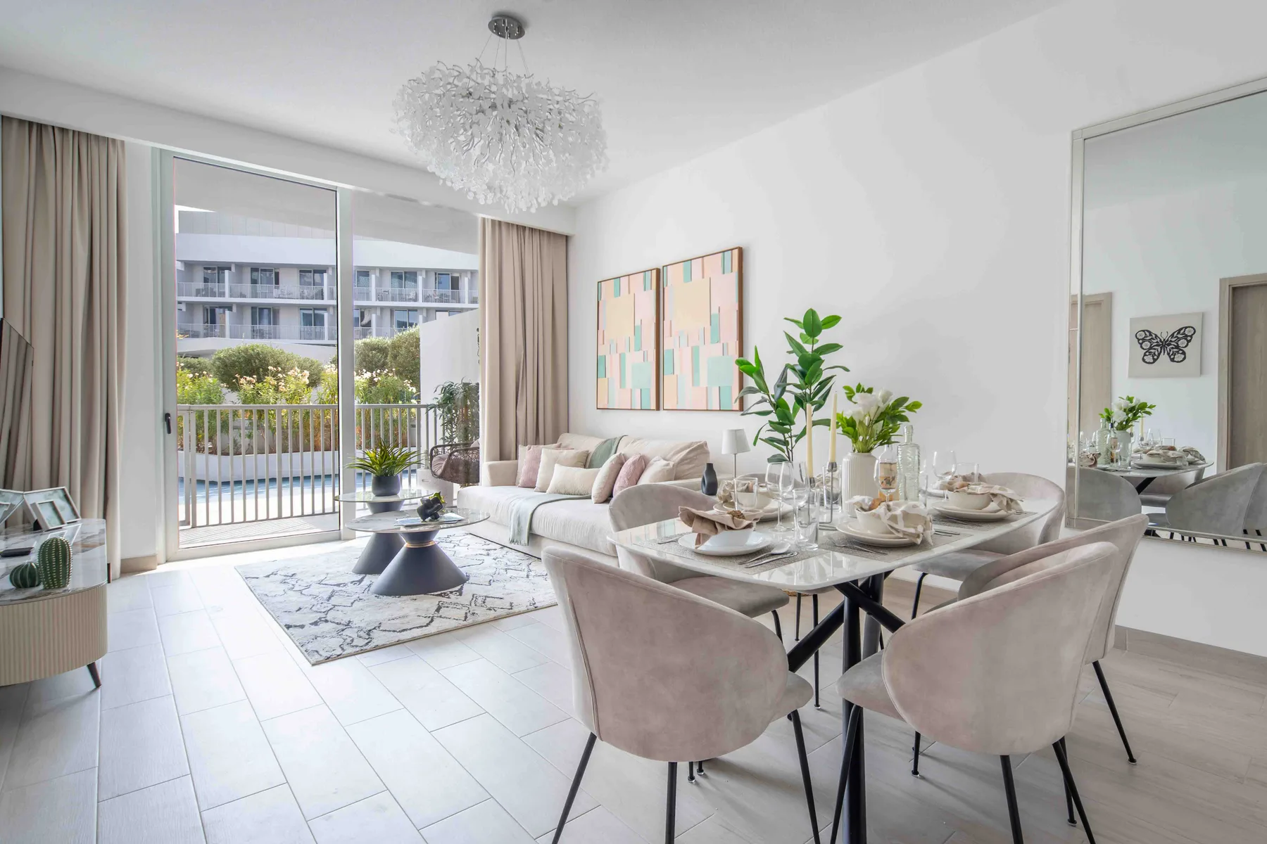 A bright living and dining area with seating beside a glass balcony door.