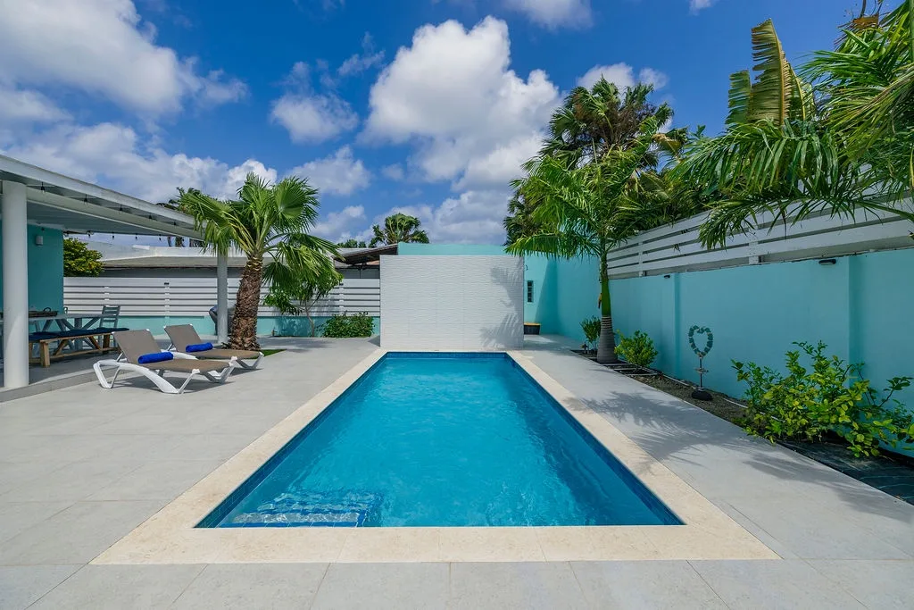 Step into your private tropical oasis, where sparkling turquoise waters beckon under vibrant palms and sunny skies. Lounge on the deck and soak in the tranquility.