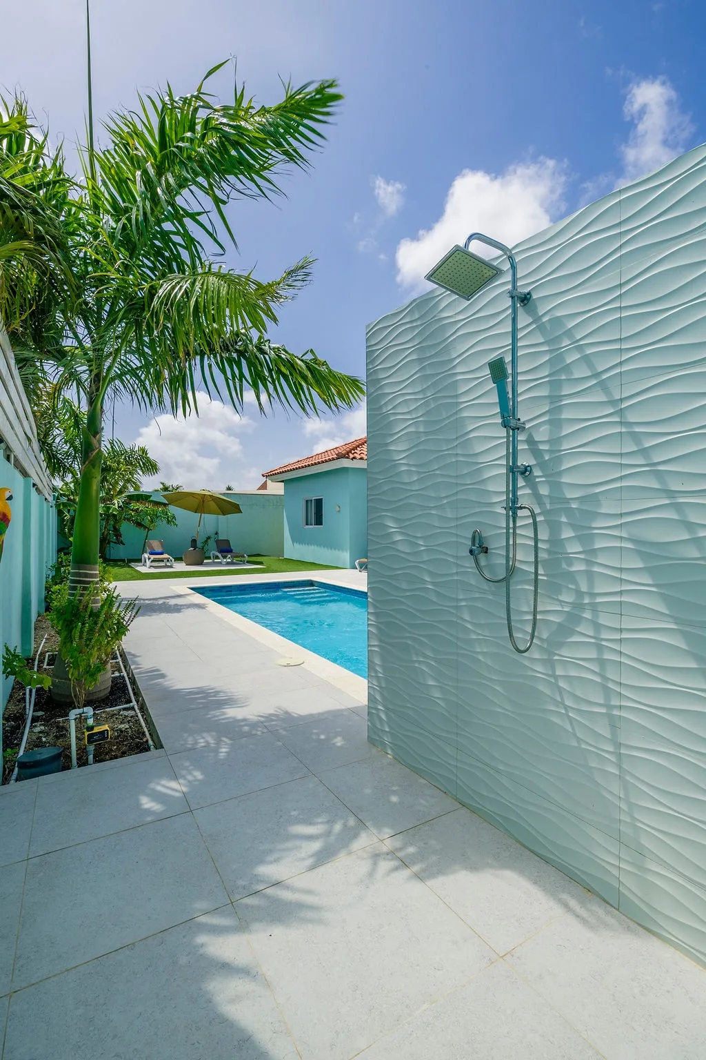 Rinse off in your private outdoor shower after a refreshing swim, surrounded by tropical palms and sunshine—it's the perfect blend of luxury and relaxation.
