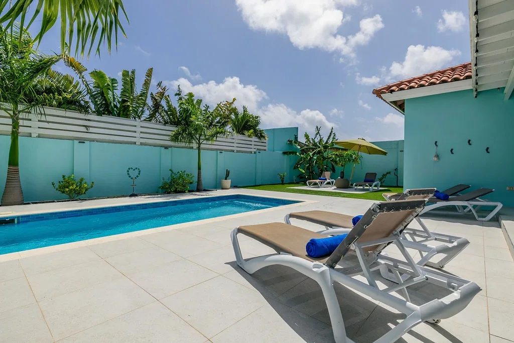 This bright private pool and sun-drenched courtyard offer your own tropical escape. Lounge on cushioned sun chairs, take a refreshing dip, or simply unwind under swaying palms in your exclusive outdoor sanctuary.