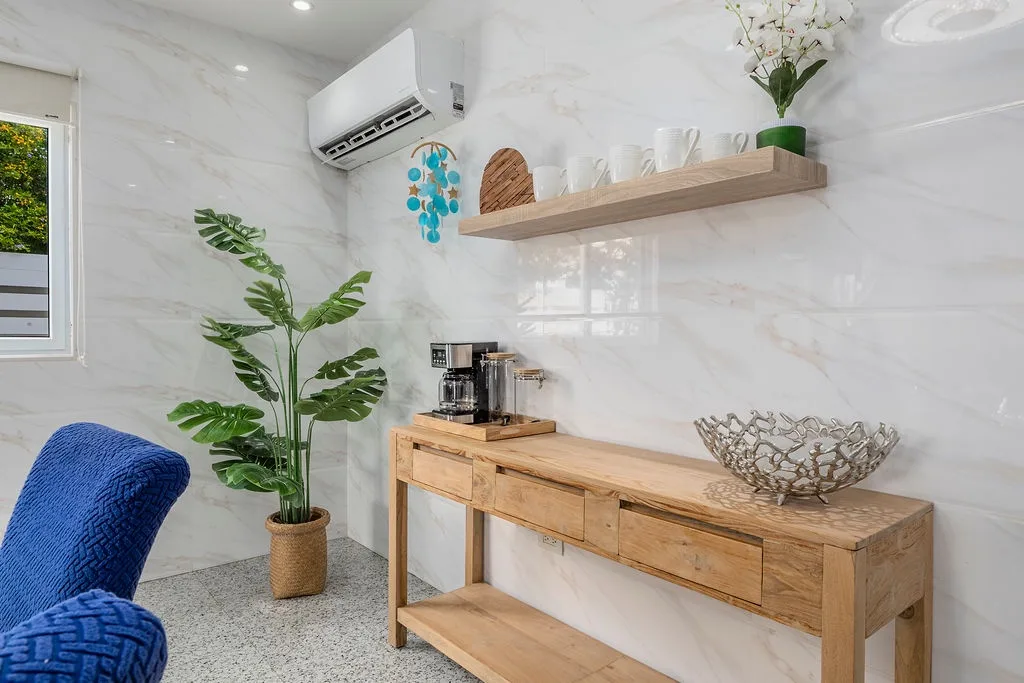 Your private coffee station awaits, set against elegant marble walls with tropical charm. An air-conditioned space where you can craft your morning brew just the way you like it.