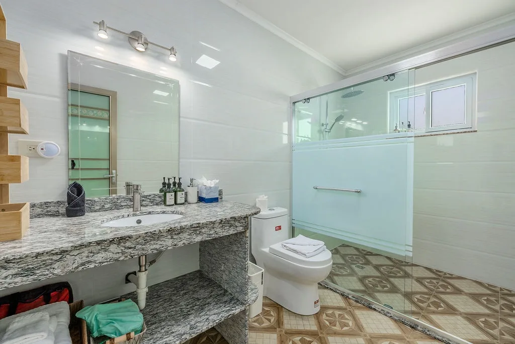 Refresh in your spacious bathroom with a sleek walk-in shower, elegant granite vanity, and plenty of room to unwind after exploring.