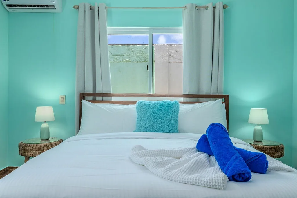 Sink into crisp white linens and wake to fresh tropical breezes in your bright, calming bedroom. Air conditioning keeps you cool, and welcoming towels await your arrival.