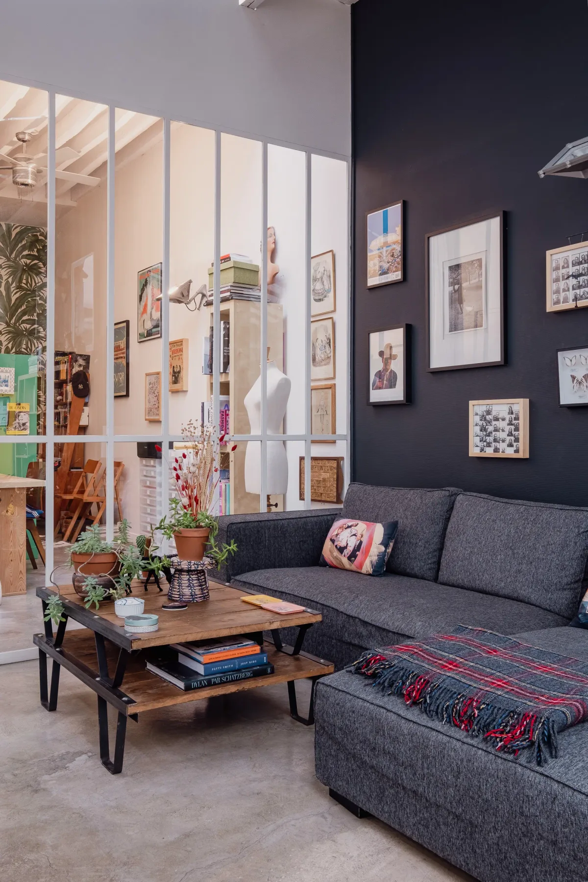 A living room with a gray sectional and a low wooden coffee table.