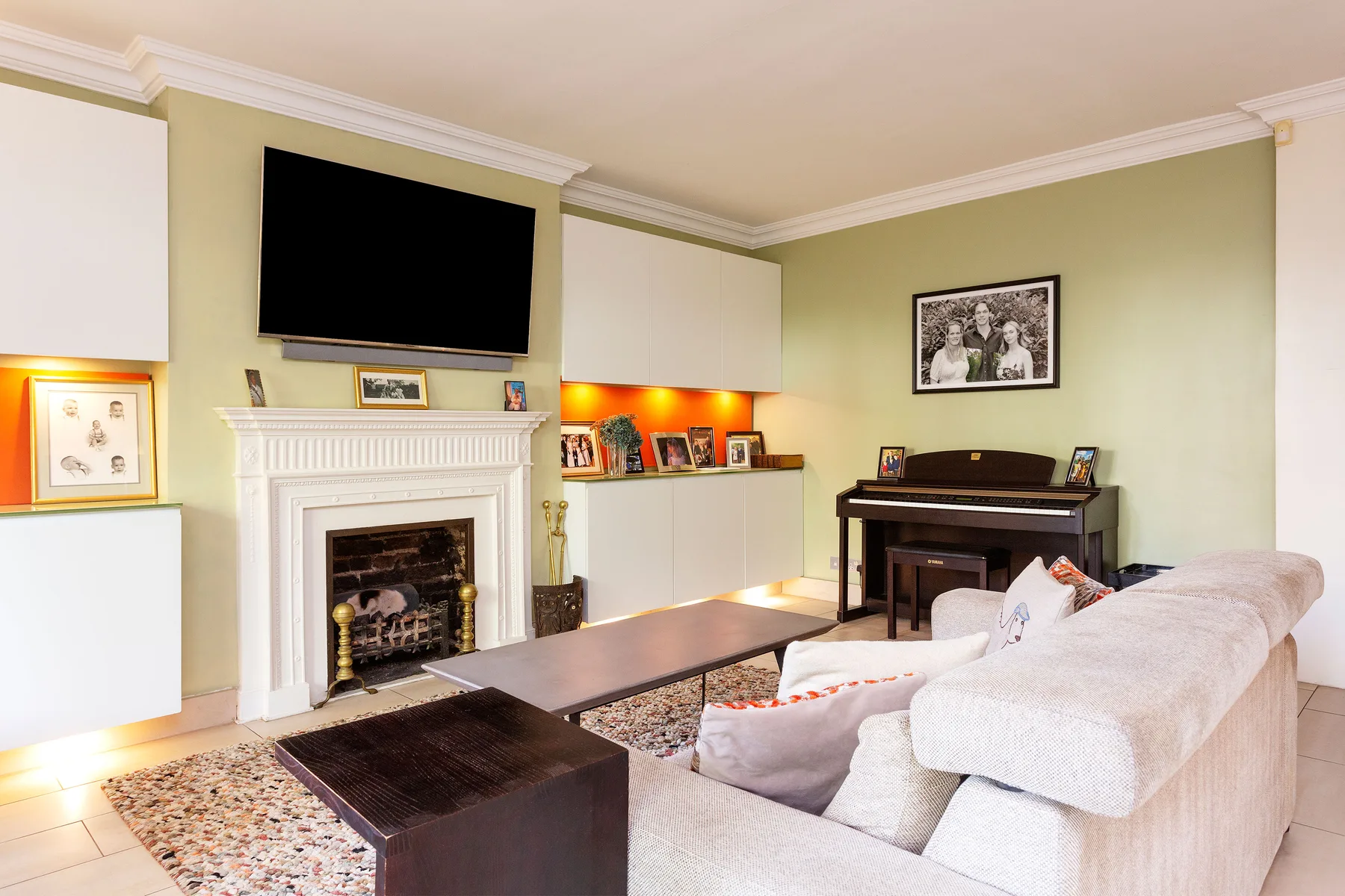 A living room with a fireplace, television, and seating.