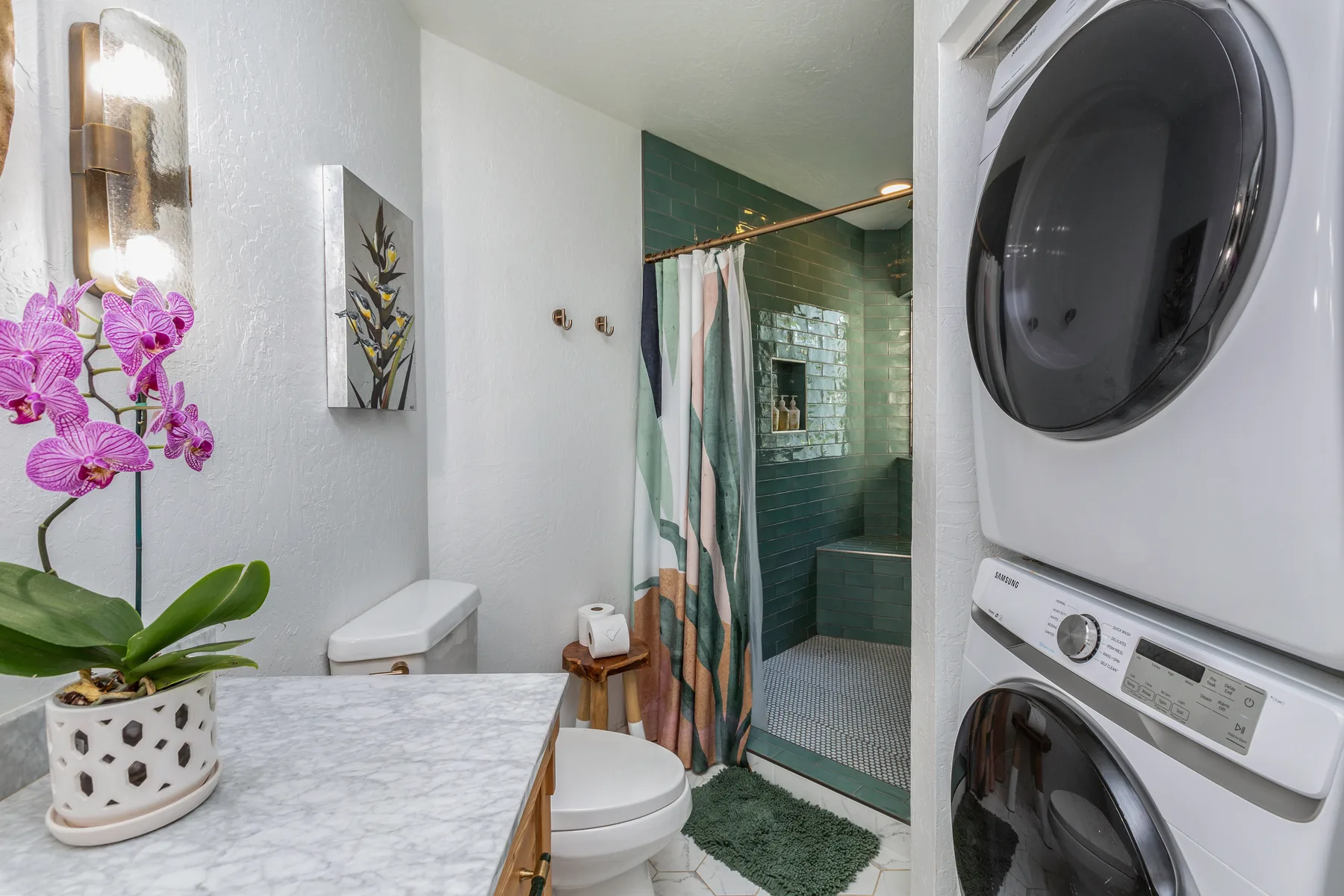 A bathroom with a sink, toilet, and glass shower.