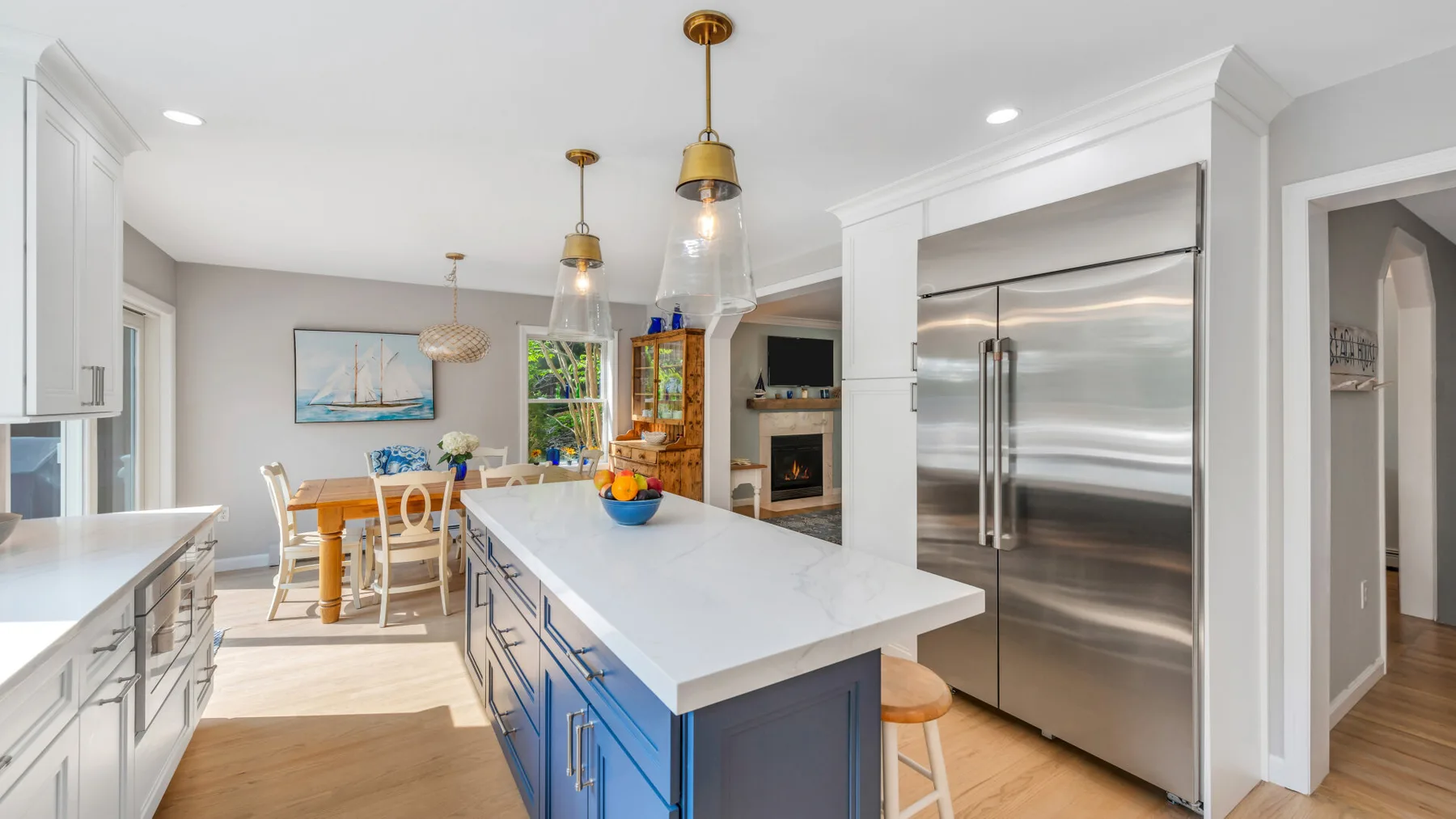 A bright kitchen with a large island and stainless steel appliances.