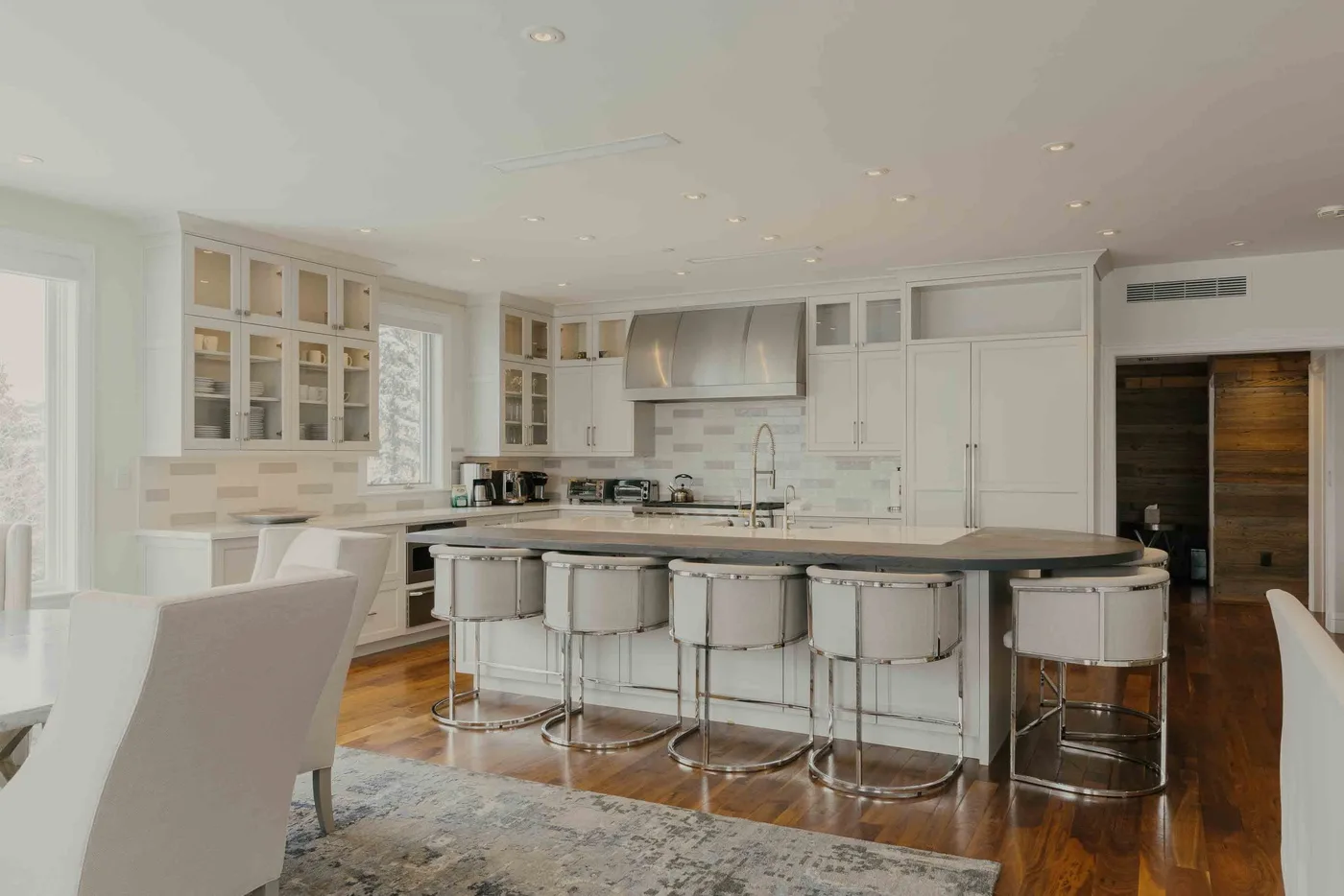 A bright kitchen with a large island and white cabinetry.