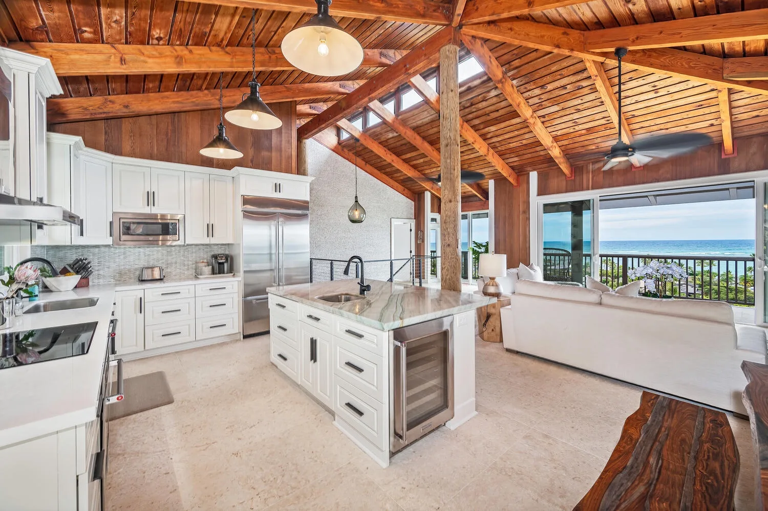 An open kitchen and living area with a large island and ocean views.