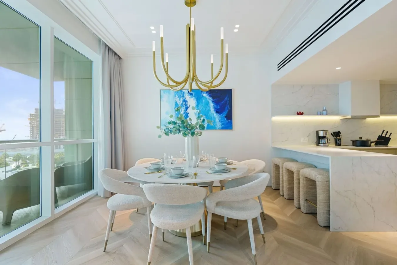 Un comedor luminoso con una mesa redonda junto a una encimera de cocina.