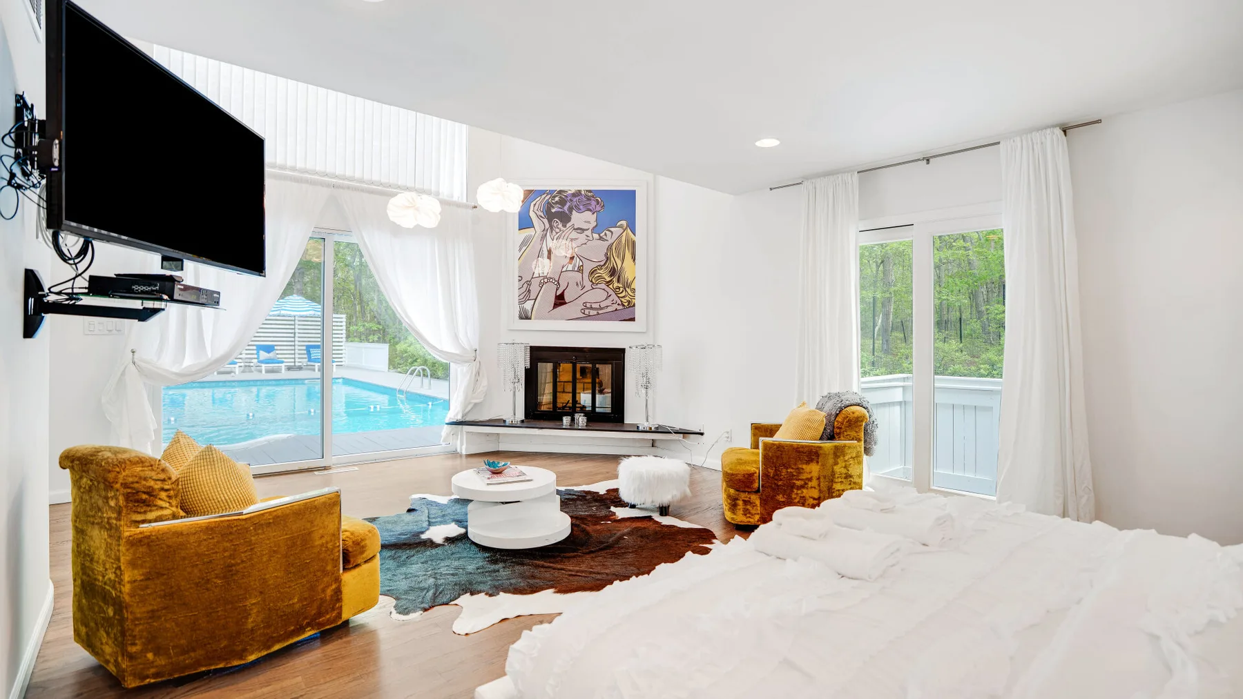 A bright living room with mustard-colored seating, a coffee table, and large windows.