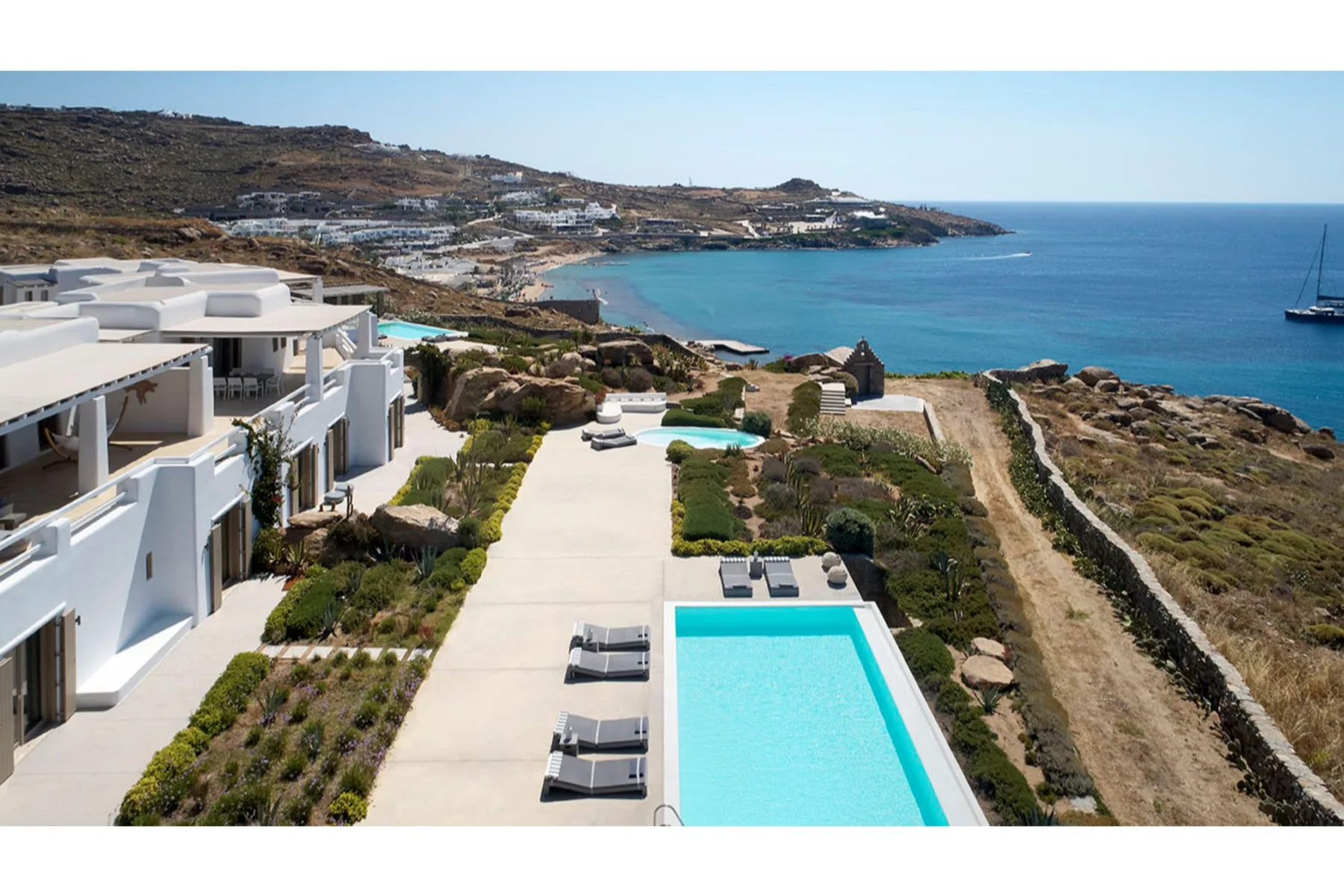 A coastal villa with a swimming pool overlooking the sea.