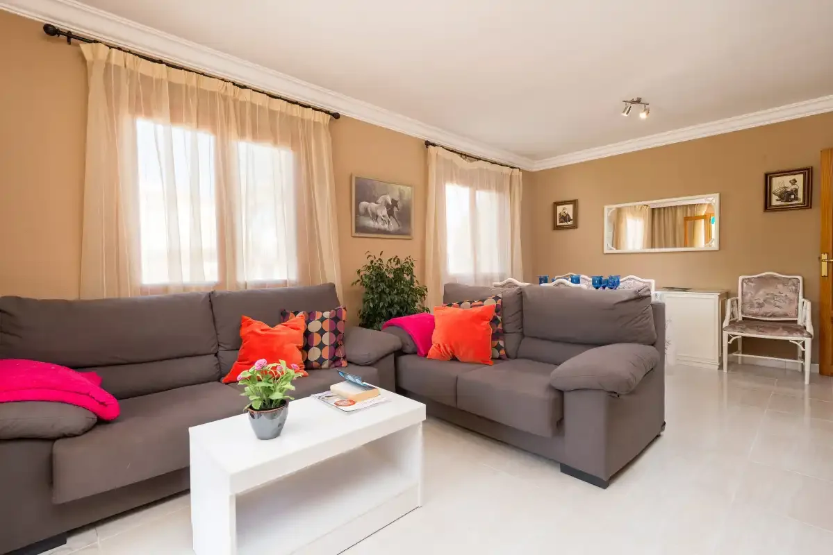 A living room with gray seating and a white coffee table.