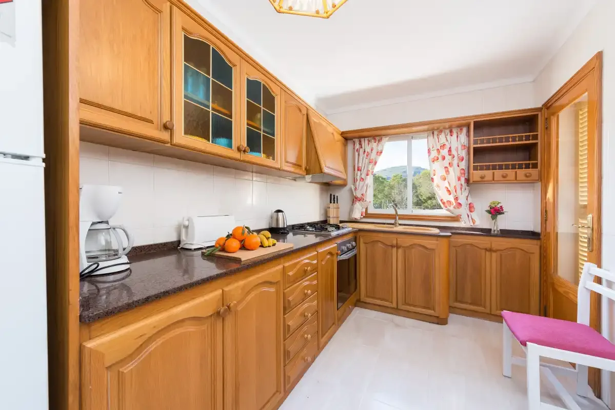A kitchen with wooden cabinetry and a countertop.