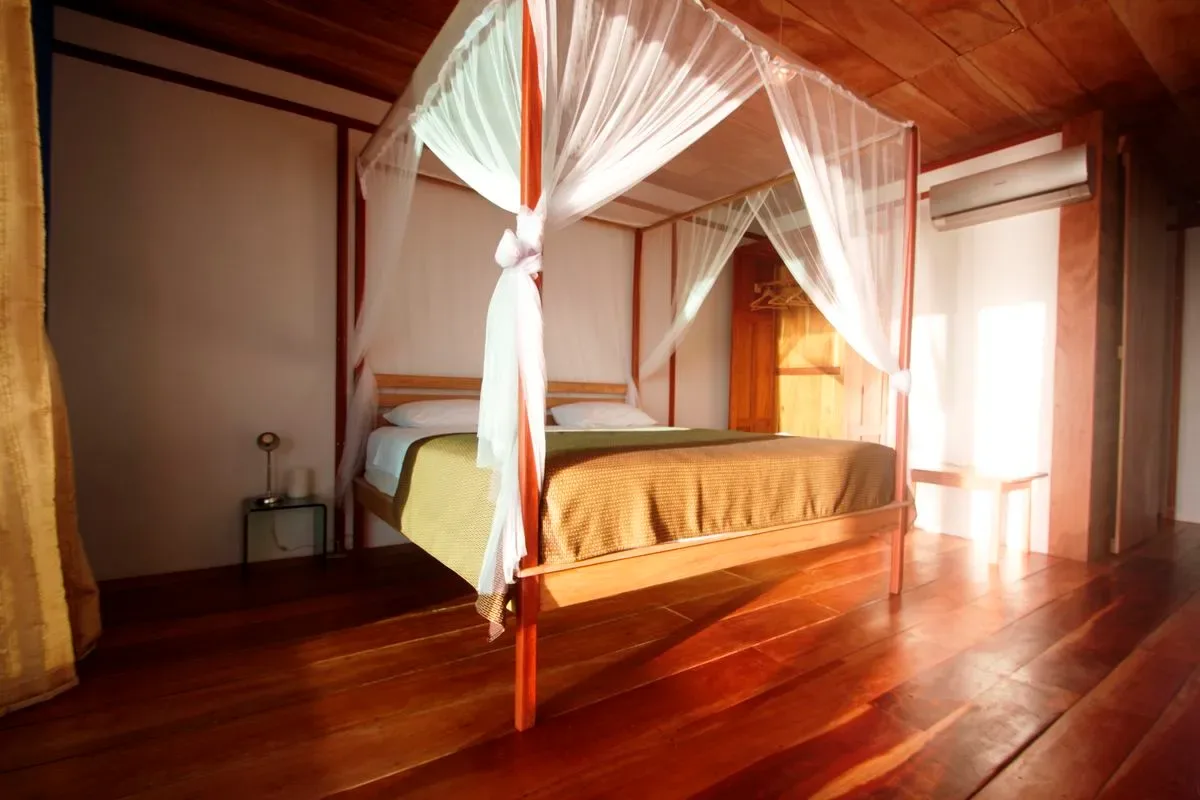 Standard room — bed with mosquito net
