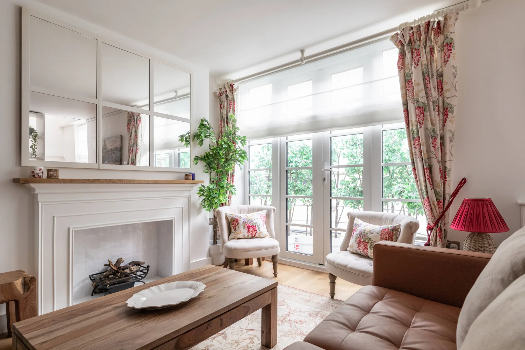 A bright living room with seating beside large glass doors and windows.