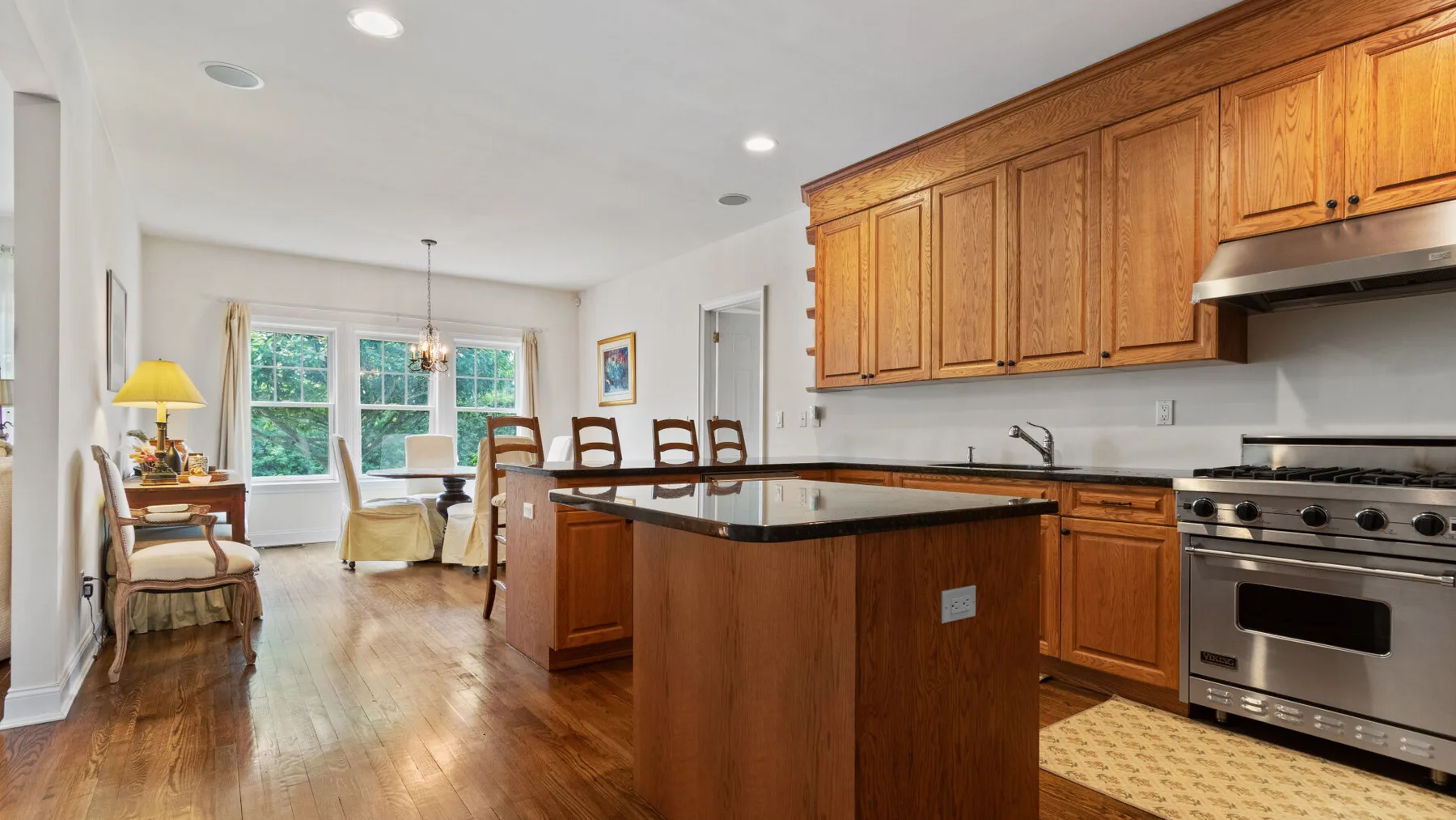 A bright kitchen and dining area with a large island and windows.
