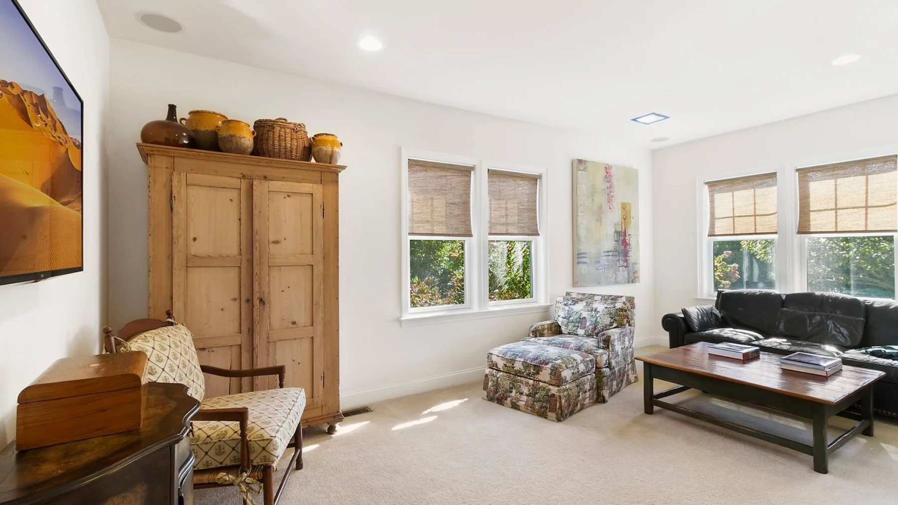 A bright living room with seating arranged around a coffee table.