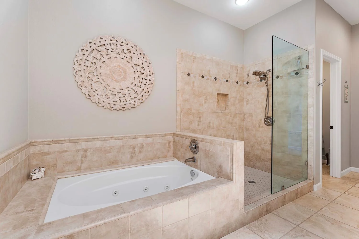 Un baño con una bañera integrada y una ducha con mampara de vidrio.