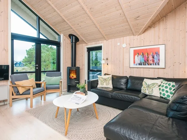 A bright living room with seating, a coffee table, and a fireplace.