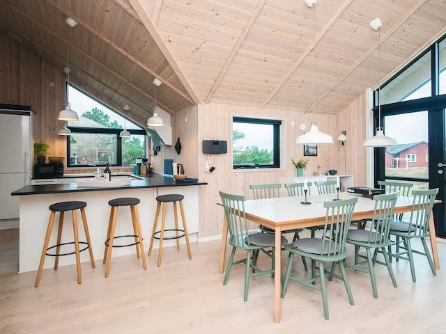 An open-plan kitchen and dining area with a counter and dining table.
