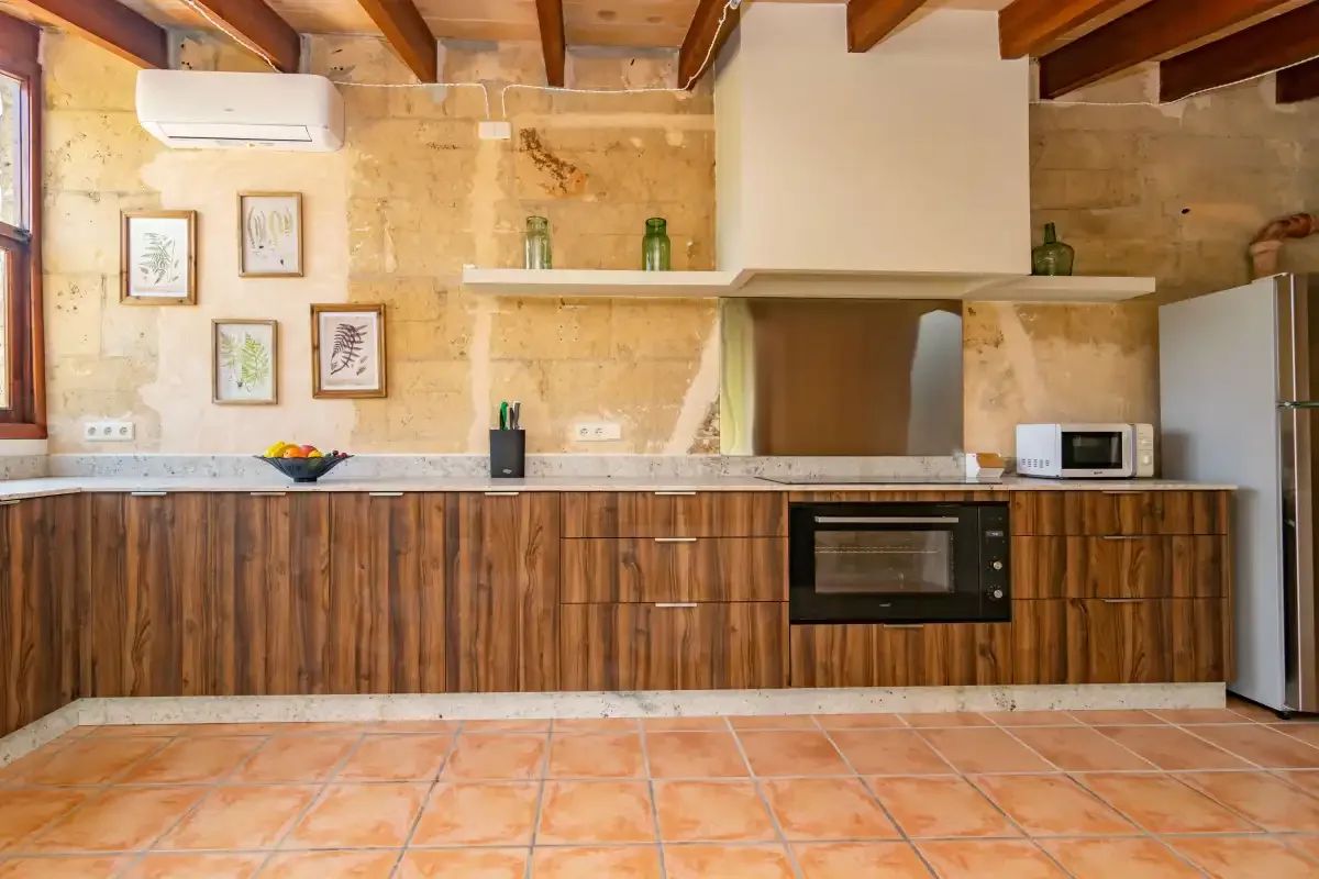 A rustic kitchen with wooden cabinets and a built-in oven.