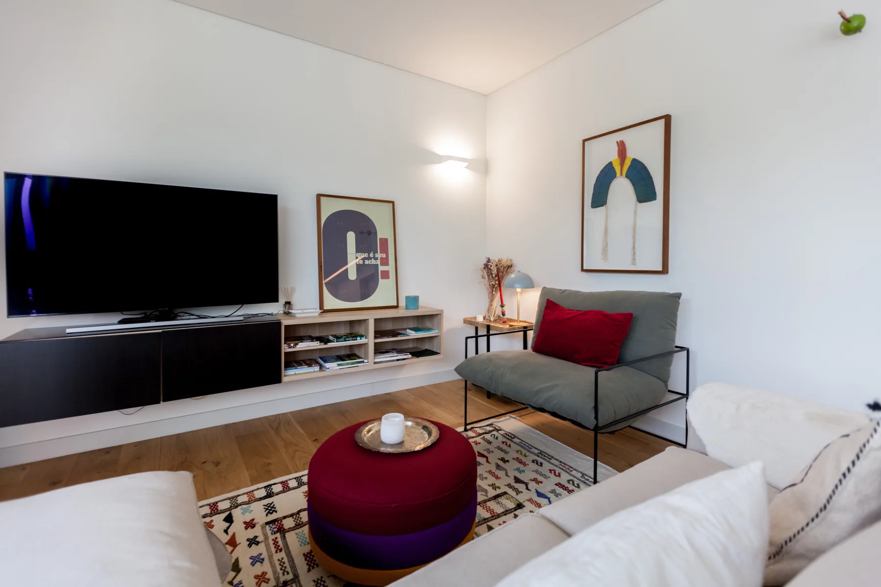 A living room with seating arranged around a television and coffee table.