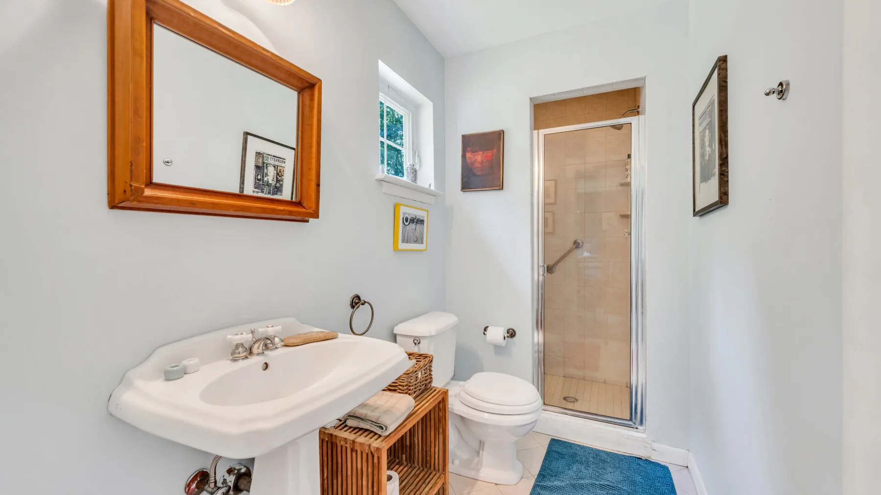 A bright bathroom with a sink, toilet, and glass shower.