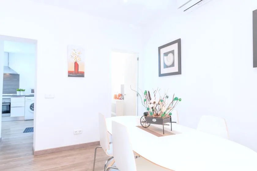 A bright dining area with a table, seating, and a decorative centerpiece.
