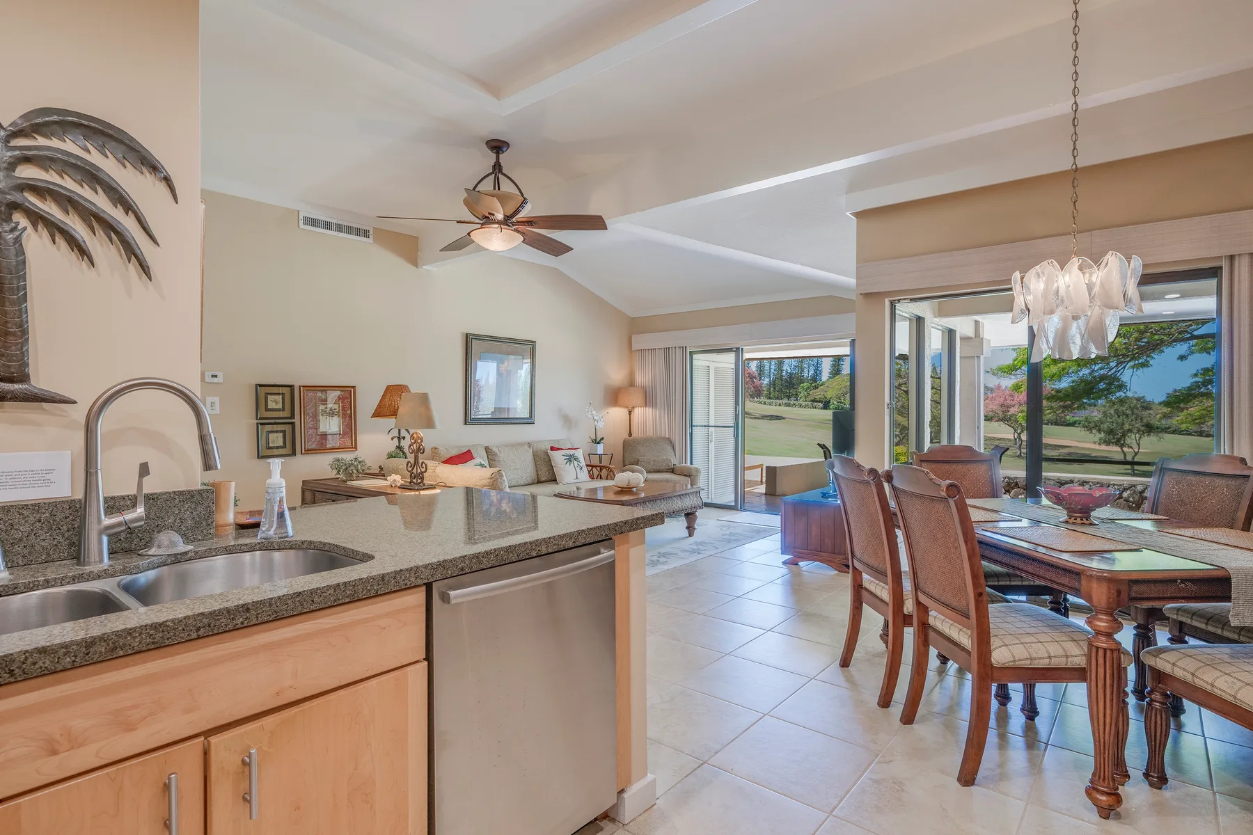 Cocina y comedor de concepto abierto con una sala de estar y puertas corredizas de vidrio.