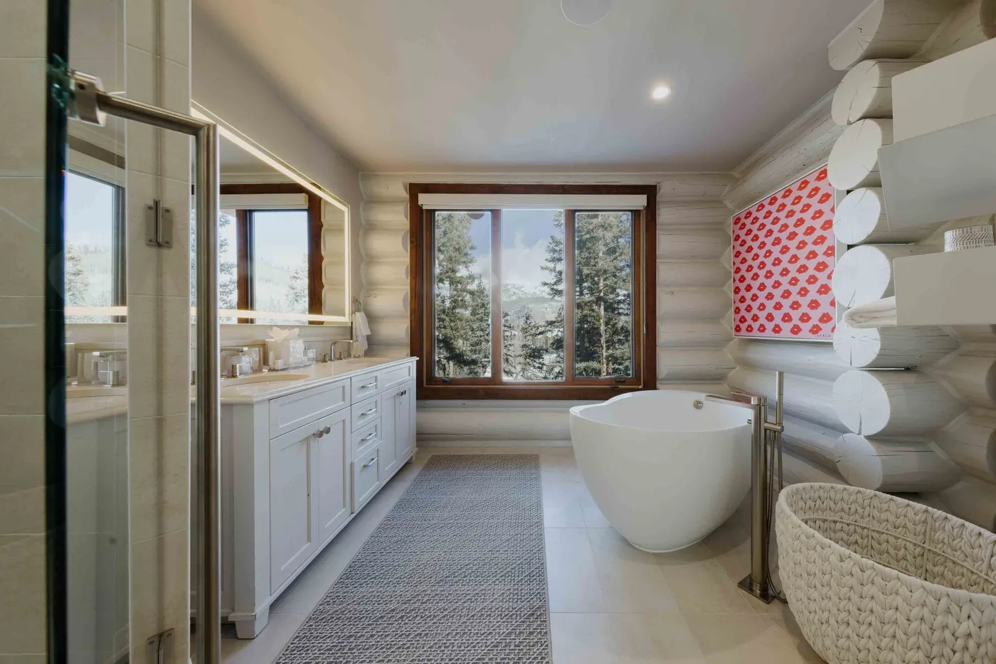 A bright bathroom with a bathtub, vanity, and large windows.