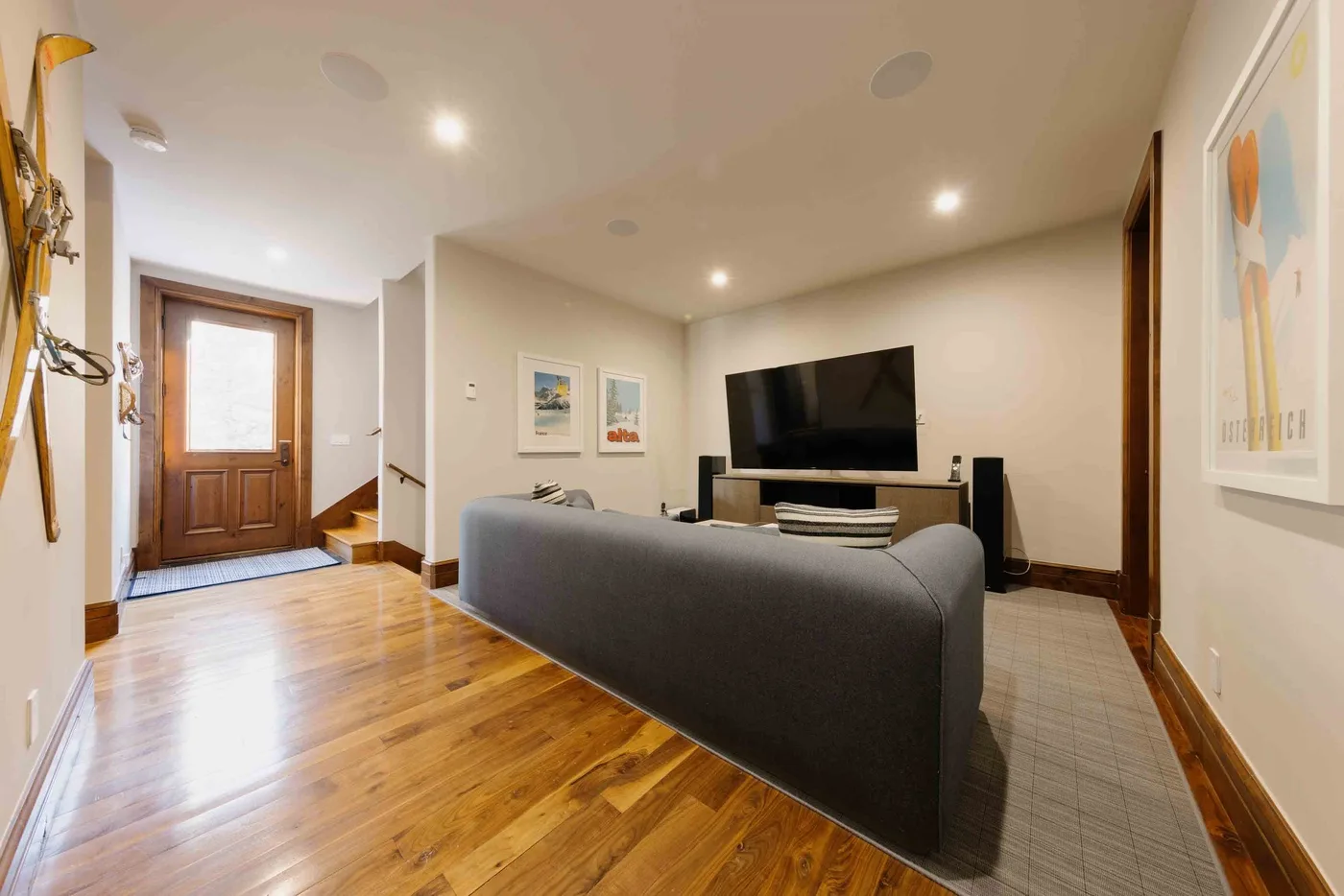 A living room with seating facing a television on a low stand.