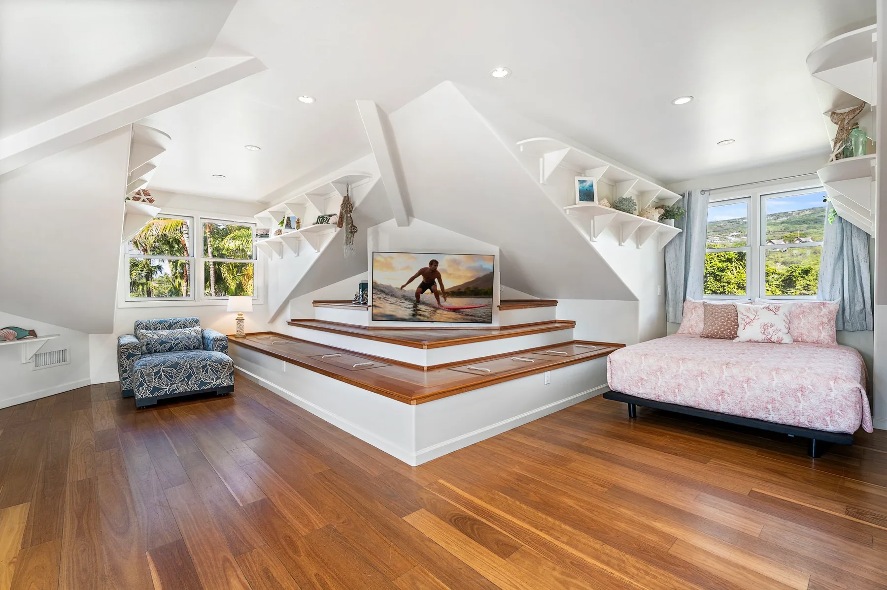 A bright attic sitting area with a raised central platform and two seating areas.
