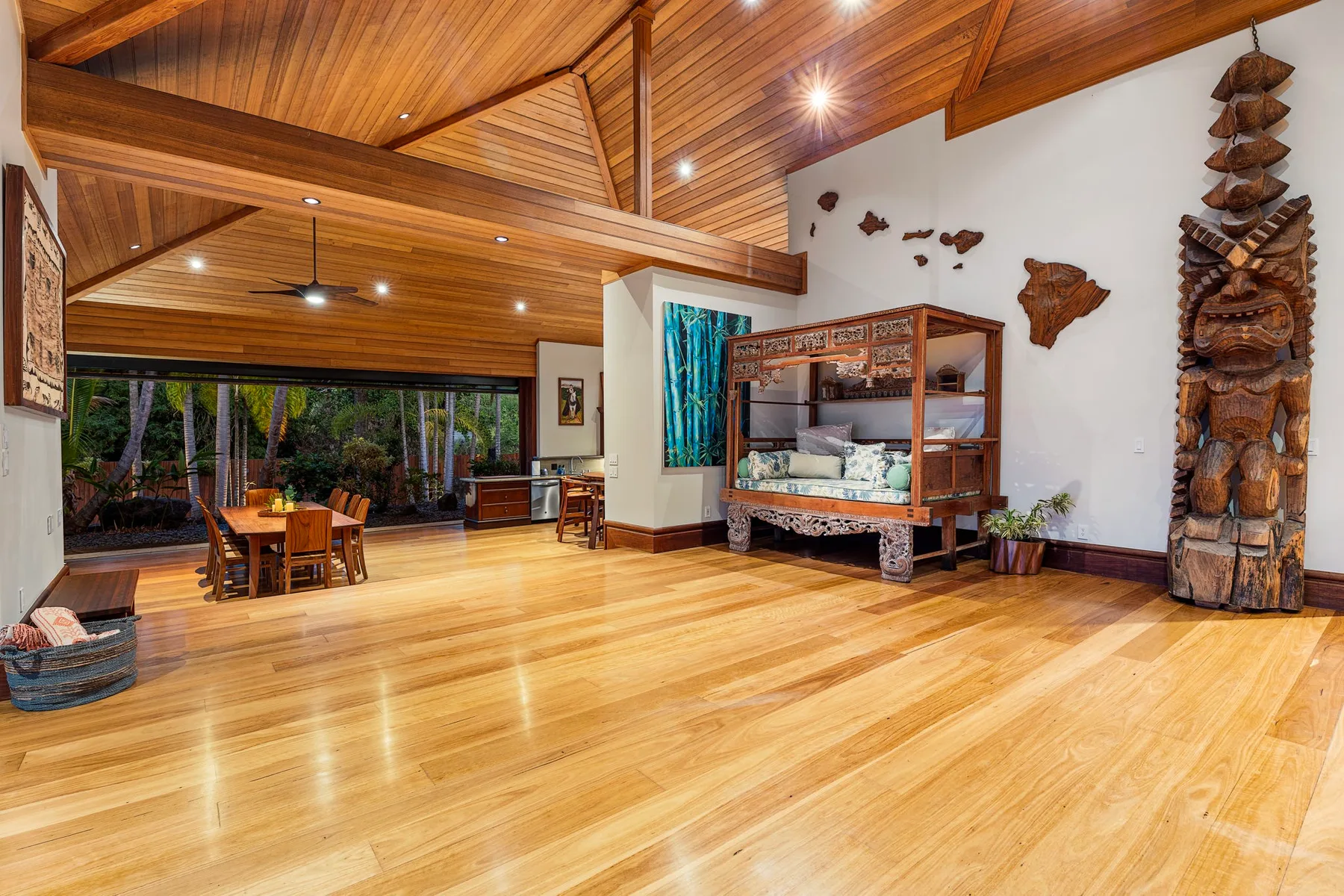 A spacious wood-paneled living room with a dining table and decorative carvings.