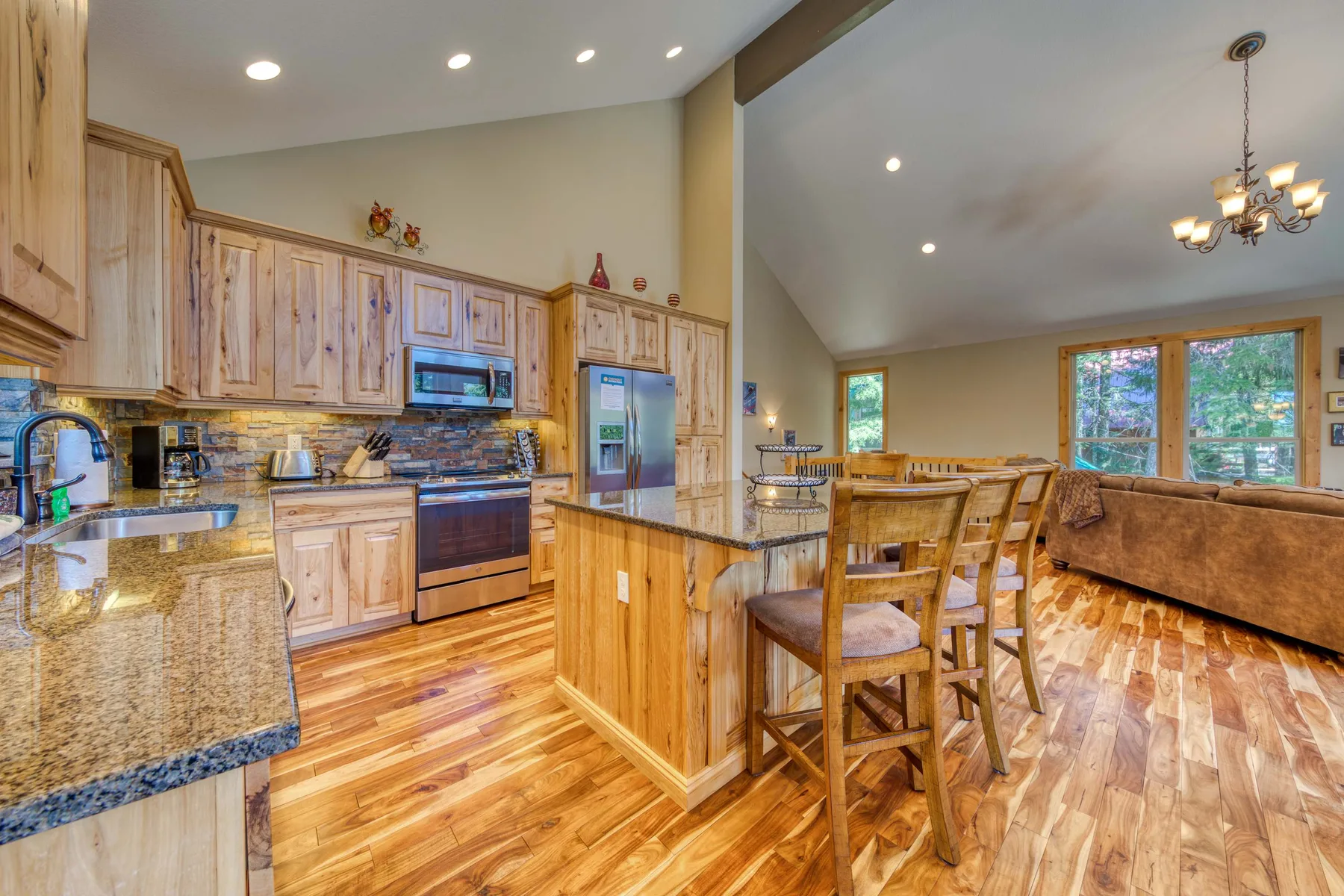 An open kitchen and dining area with wooden cabinetry and a dining table.
