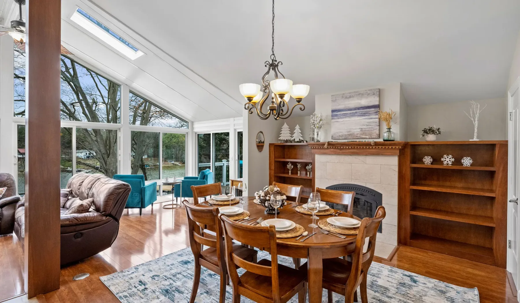 A dining area with a wooden table and chairs beside a bright living area.