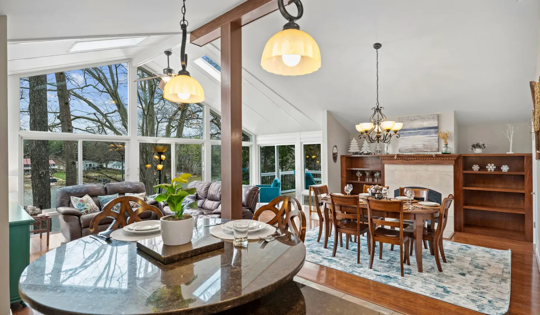 A bright dining area with a large table beside expansive windows.