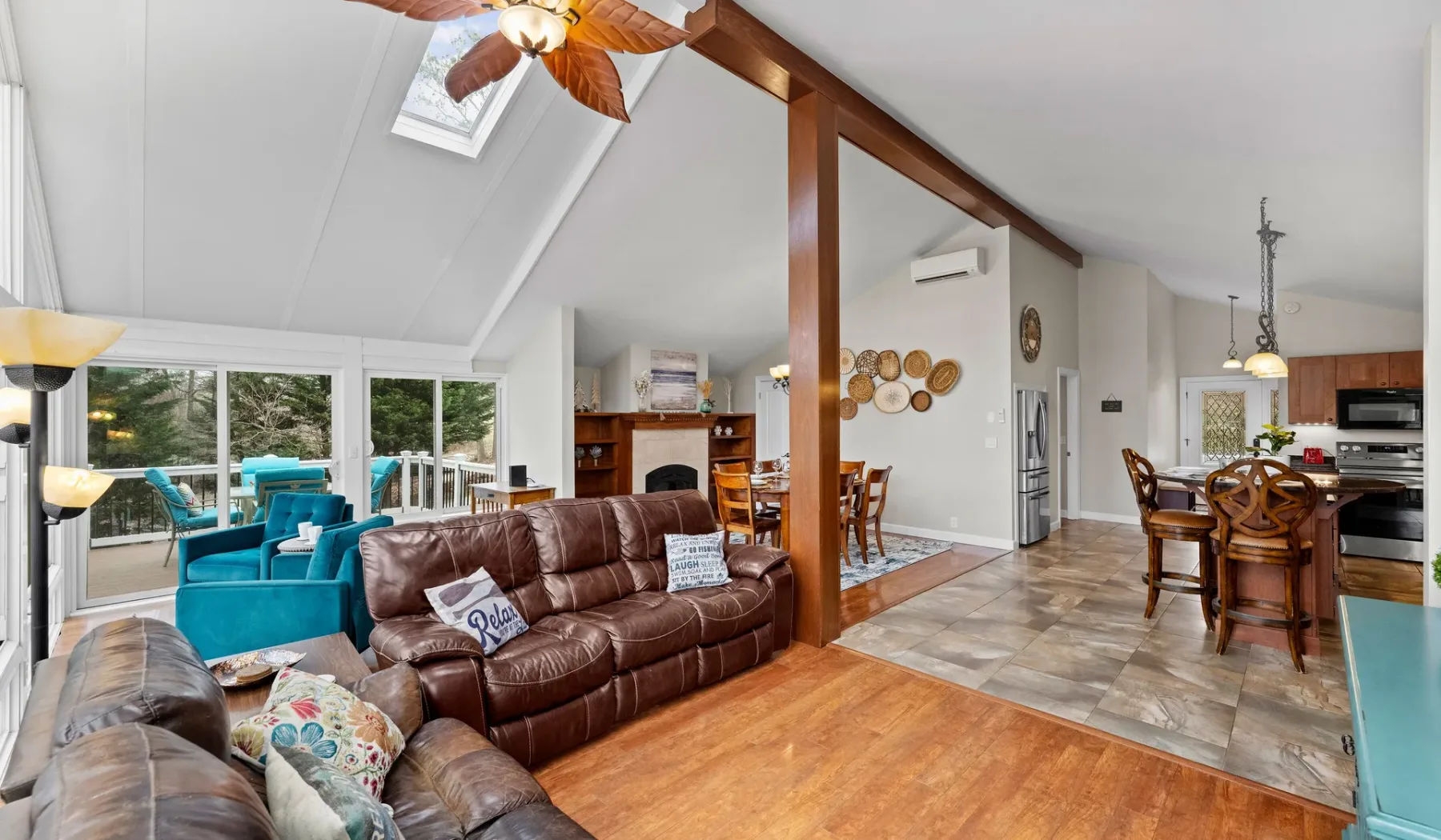 Open-plan living room with brown seating and a dining area.