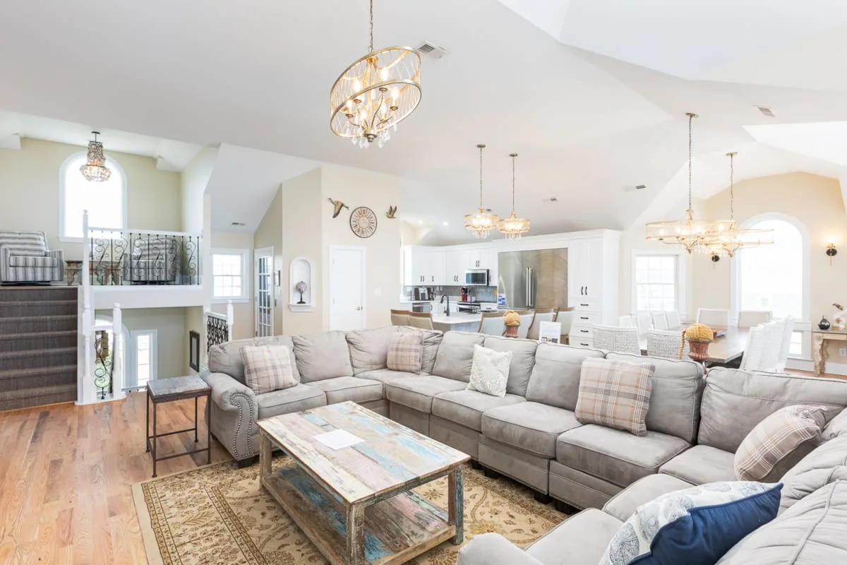 A spacious living room with sectional seating and a coffee table.