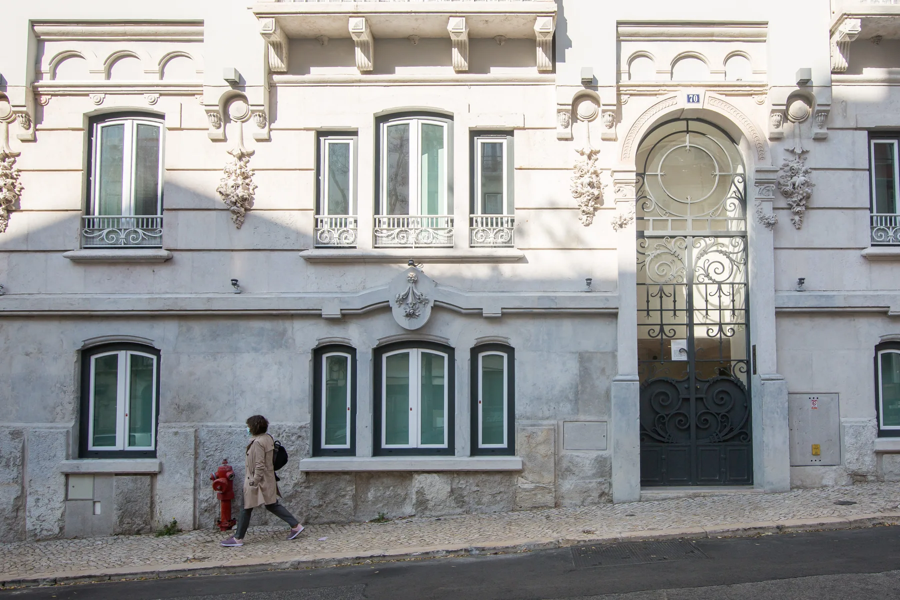 An ornate building facade with tall windows and a decorative arched entrance.