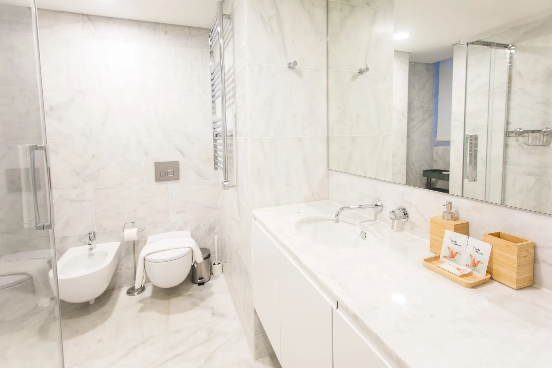 A bright bathroom with a bathtub, sink, and toilet.