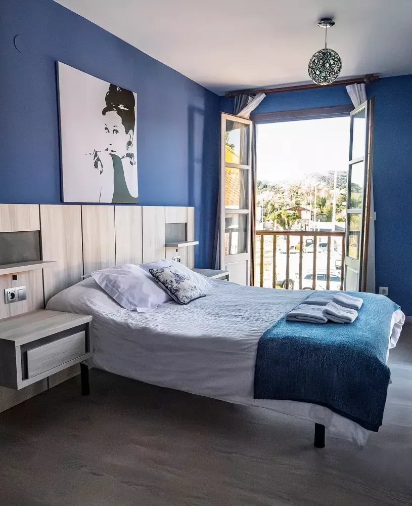 Double bed and private balcony in room 102