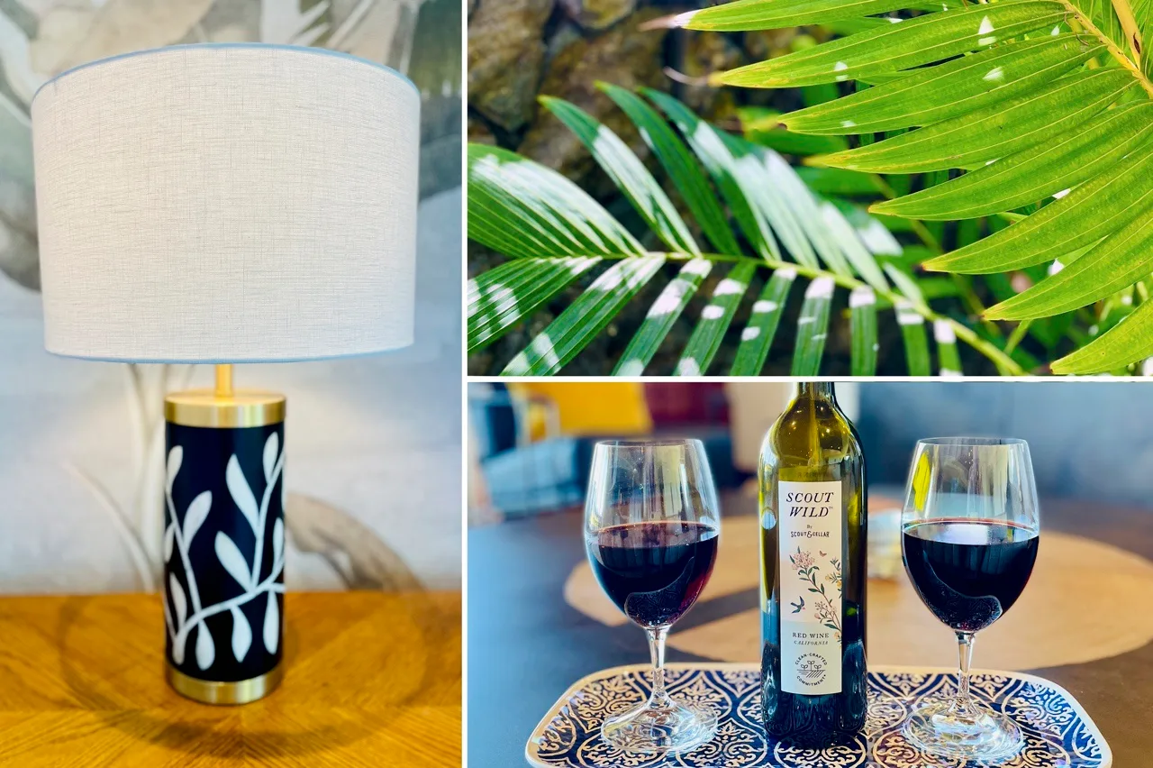 Una lámpara decorativa aparece junto a primeros planos de hojas verdes y copas de vino.