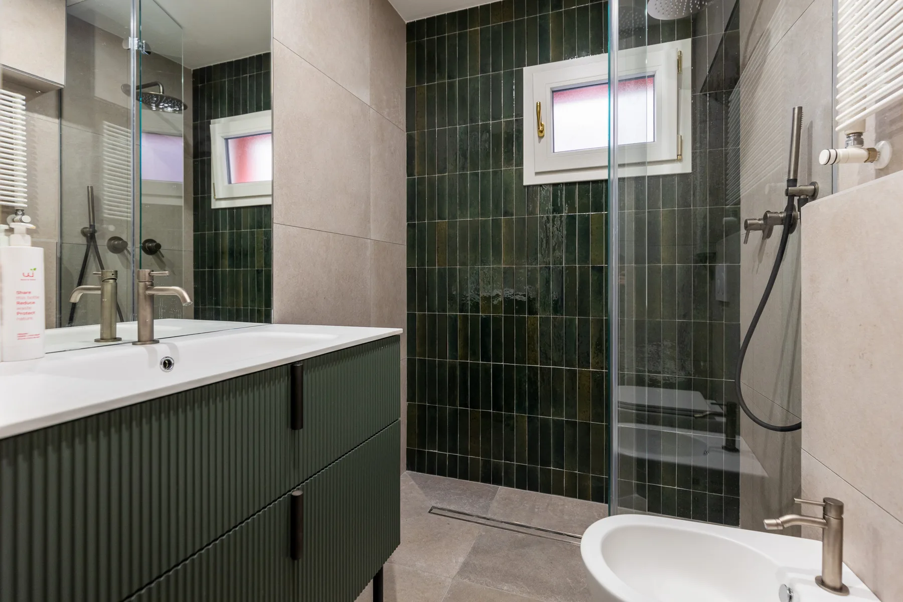 A modern bathroom with a sink vanity, shower, and bathtub.