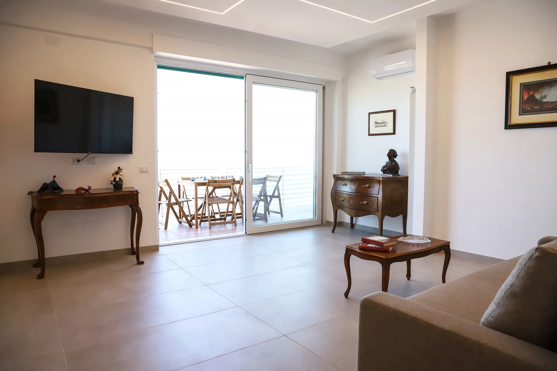 A bright living room with sliding glass doors opening onto a balcony.