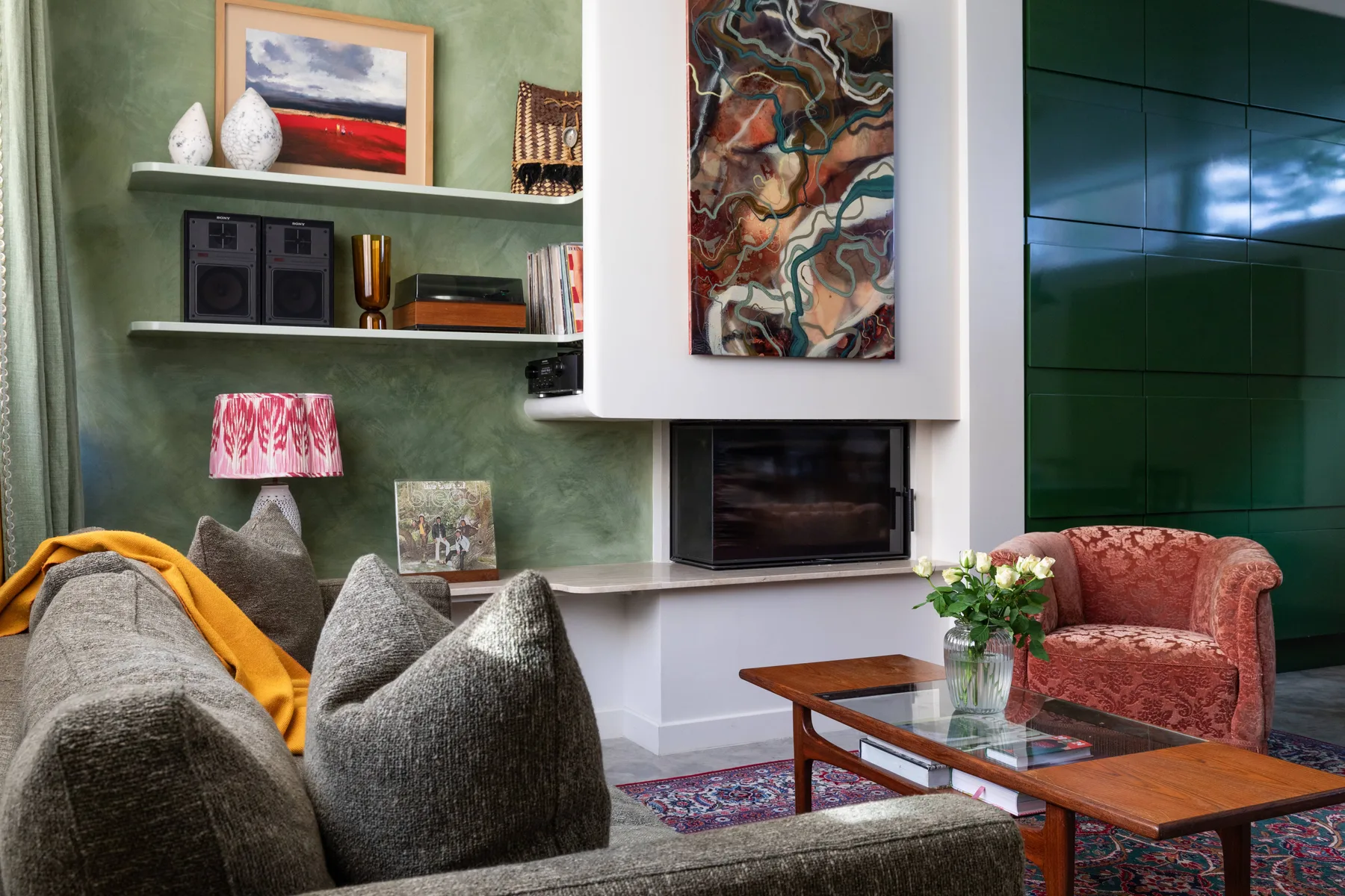Living room with a fireplace, seating, and a coffee table.