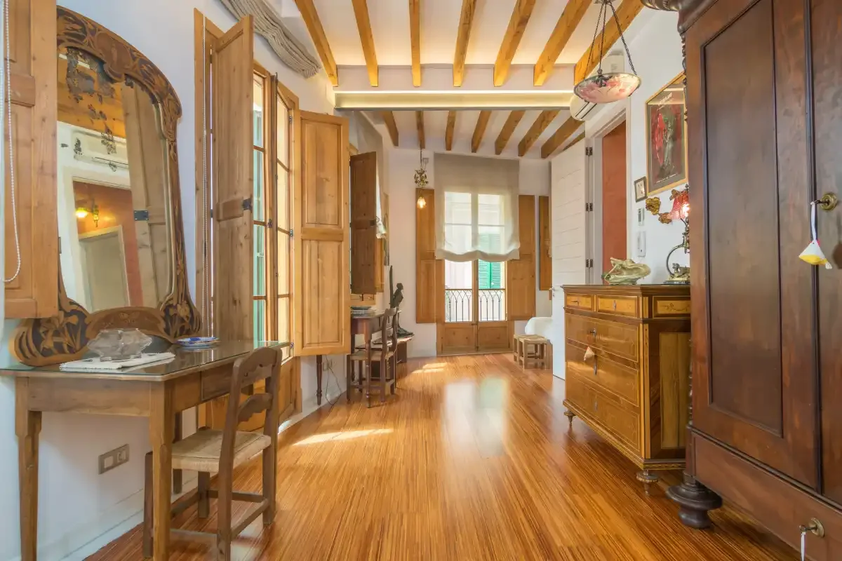 A traditional room with wooden furniture and exposed ceiling beams.