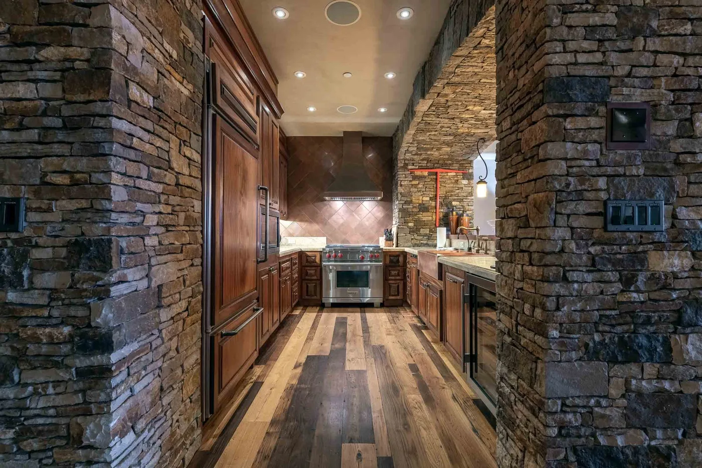 A kitchen with wooden cabinetry and a central cooking area.