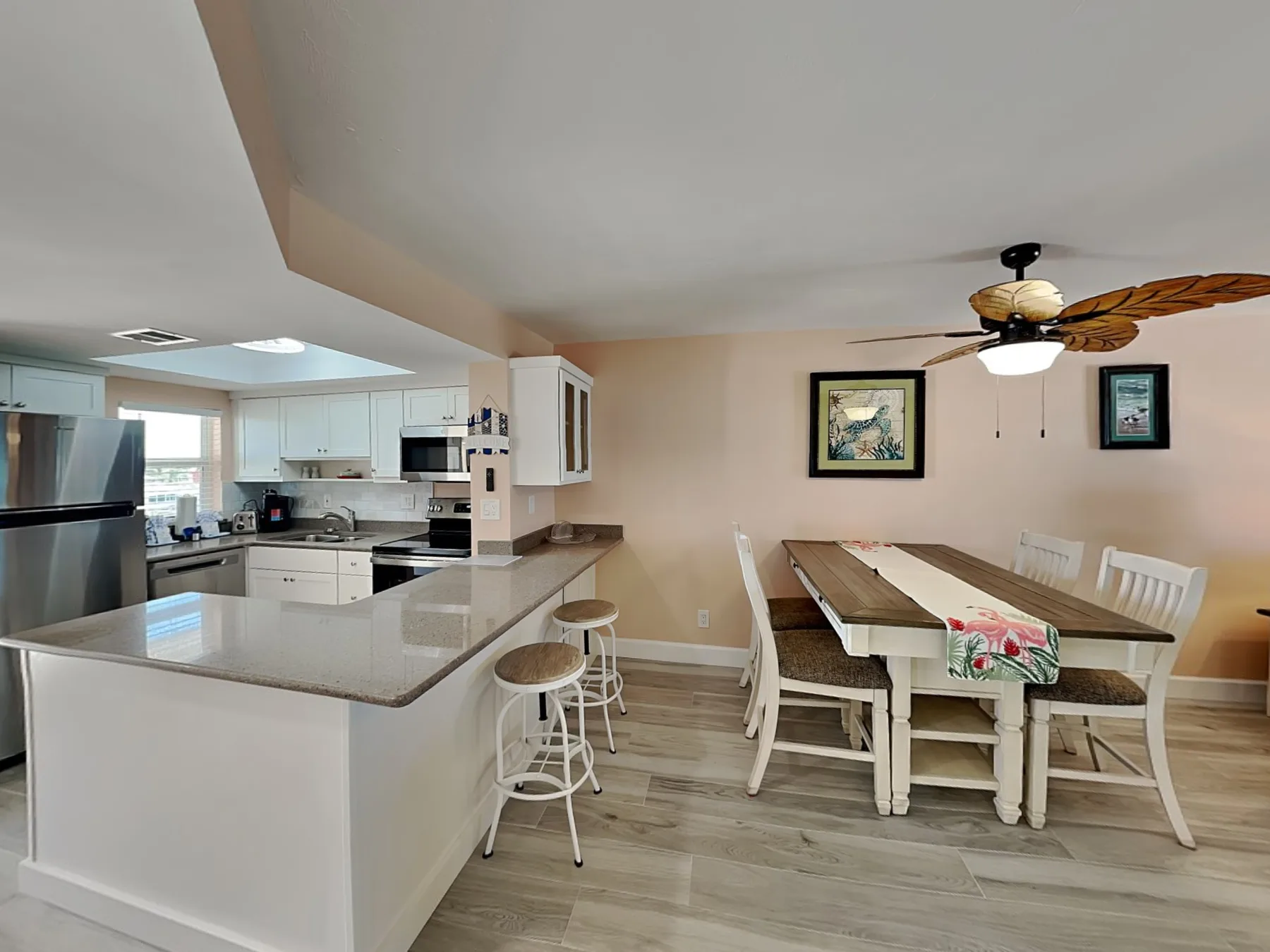 An open kitchen and dining area with a long table beside the kitchen island.